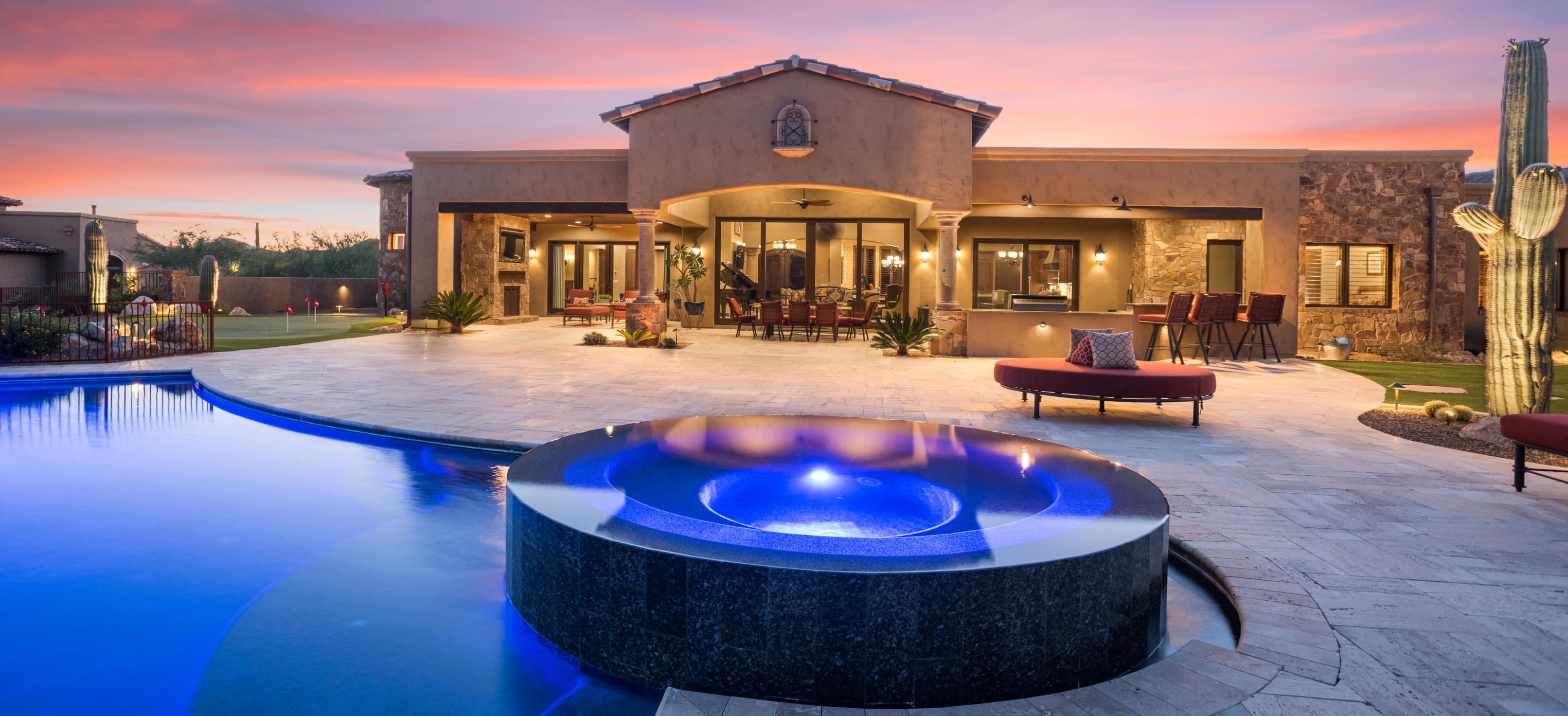 custom lighting in a custom pool and spa in a luxury backyard